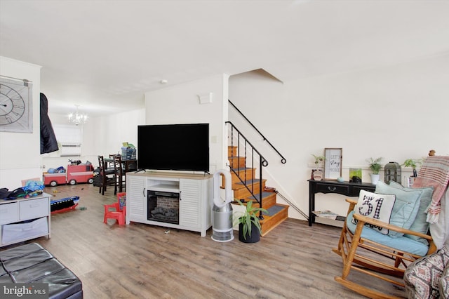 living room featuring a notable chandelier and hardwood / wood-style floors