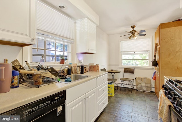 kitchen featuring white cabinets, black dishwasher, plenty of natural light, and sink