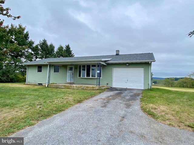 ranch-style home with a garage and a front lawn