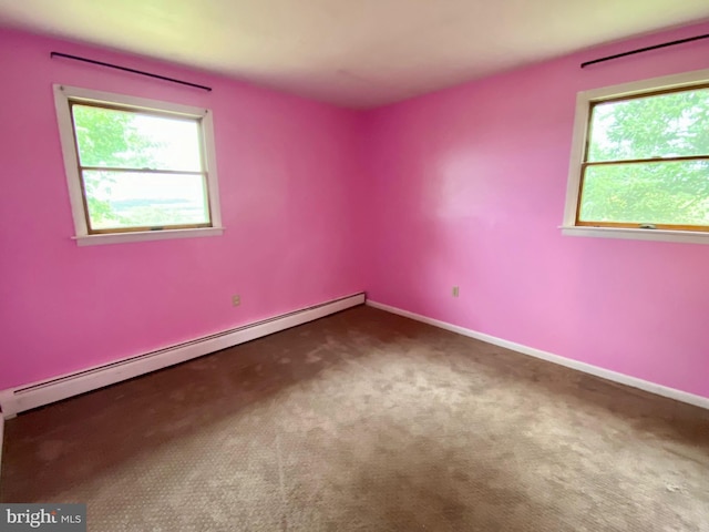 carpeted spare room with plenty of natural light and baseboard heating