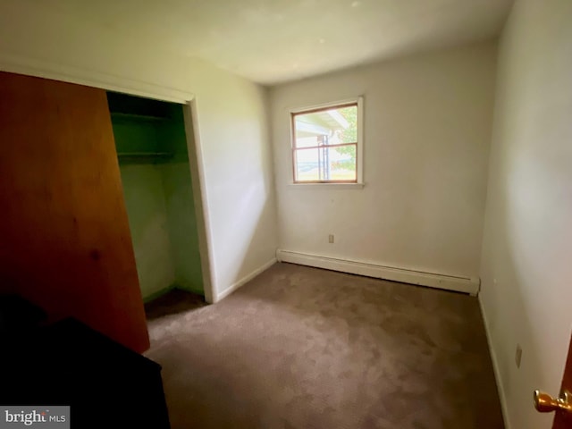 unfurnished bedroom featuring a closet, carpet, and a baseboard radiator