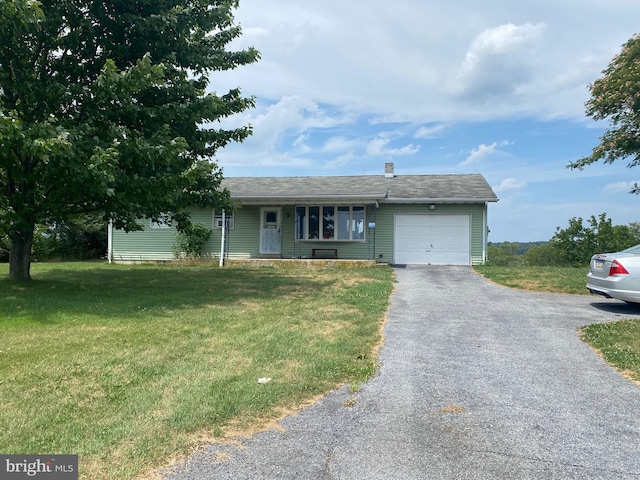 single story home with a garage and a front lawn