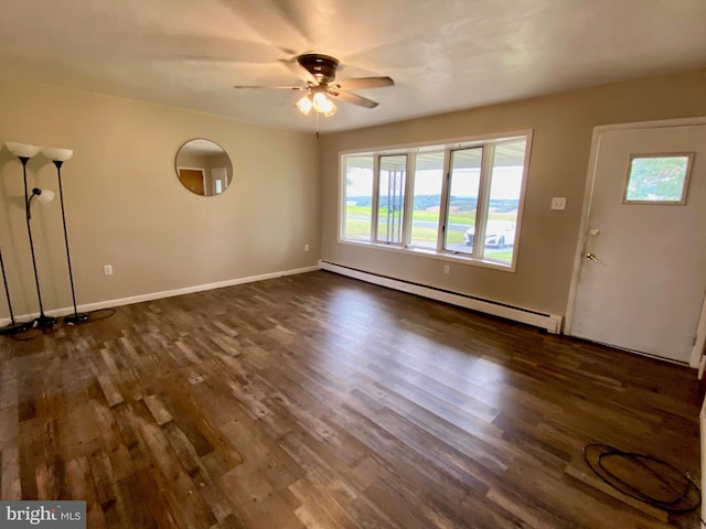 interior space featuring ceiling fan, a baseboard heating unit, and dark hardwood / wood-style flooring