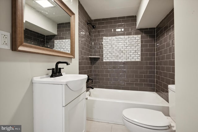 full bathroom featuring tiled shower / bath, vanity, toilet, and tile patterned floors