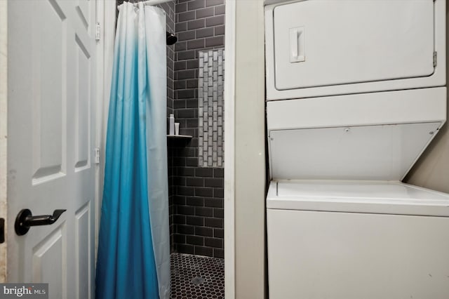 laundry area featuring stacked washer / drying machine