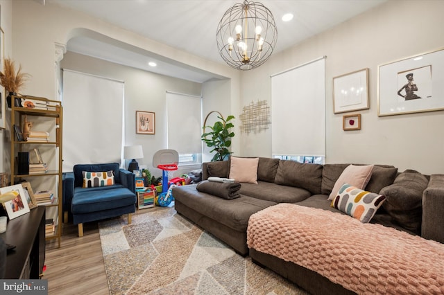 living room featuring light wood-type flooring and an inviting chandelier