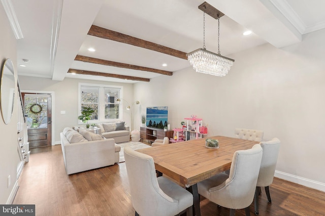 dining area with beamed ceiling, a chandelier, and dark hardwood / wood-style floors