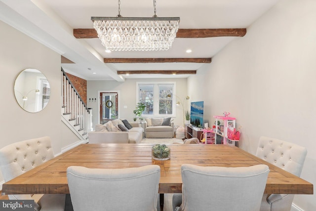 dining space featuring a notable chandelier and beam ceiling