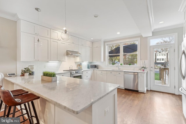 kitchen with kitchen peninsula, white cabinetry, hanging light fixtures, and stainless steel appliances