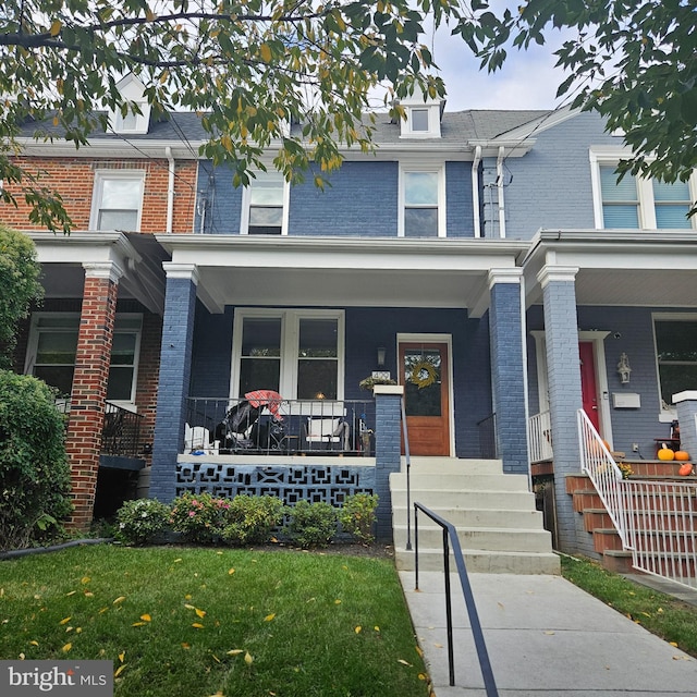 townhome / multi-family property featuring a porch