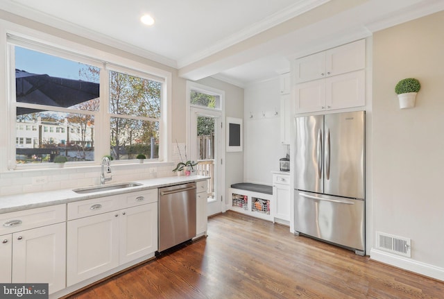 kitchen with white cabinets, wood-type flooring, sink, and appliances with stainless steel finishes