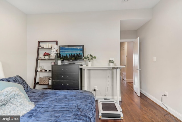 bedroom with dark wood-type flooring