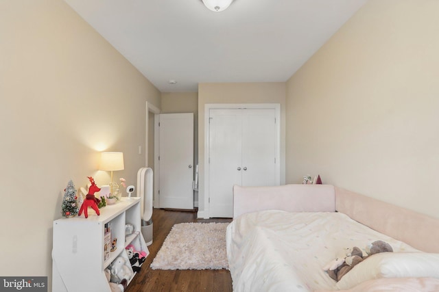 bedroom with a closet and dark wood-type flooring