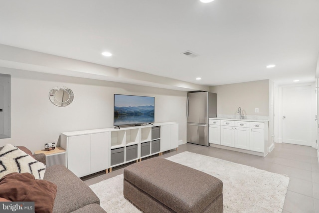 tiled living room with electric panel and sink