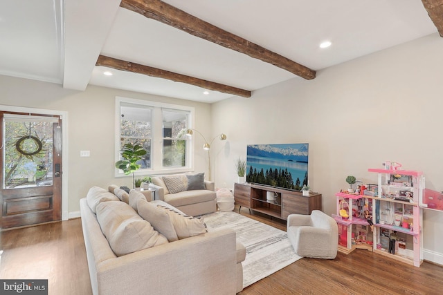 living room with beam ceiling, dark hardwood / wood-style flooring, and a healthy amount of sunlight