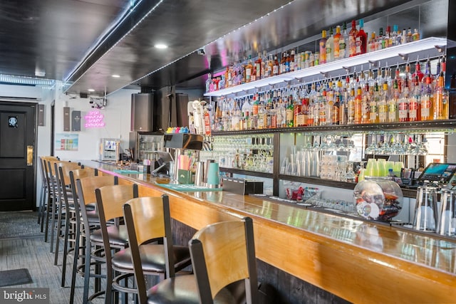 bar featuring a wall unit AC