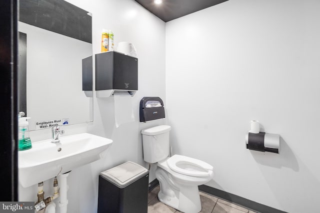 bathroom with toilet and tile patterned floors