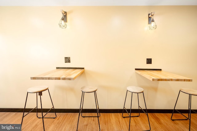 bar featuring wooden counters and hardwood / wood-style flooring