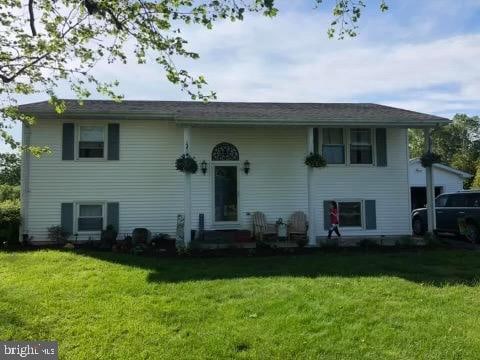 rear view of property with a lawn