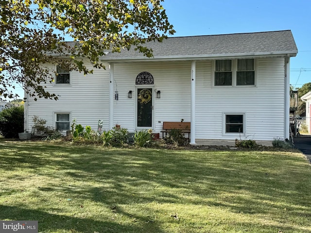 raised ranch featuring a front lawn