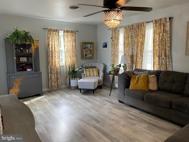 living room featuring light hardwood / wood-style flooring and ceiling fan