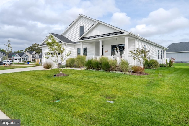 view of front facade with a garage, a porch, and a front yard