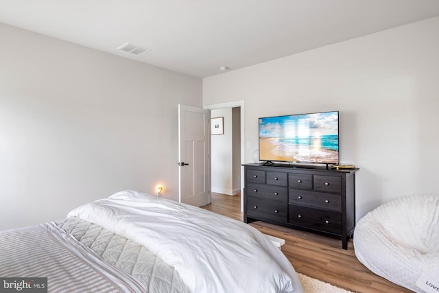 bedroom with hardwood / wood-style floors