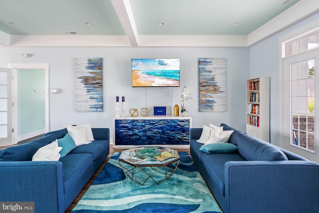 living room with hardwood / wood-style floors and beam ceiling