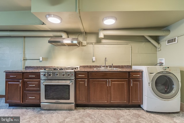 kitchen featuring sink, dark brown cabinets, wall chimney range hood, washer / clothes dryer, and high end stove