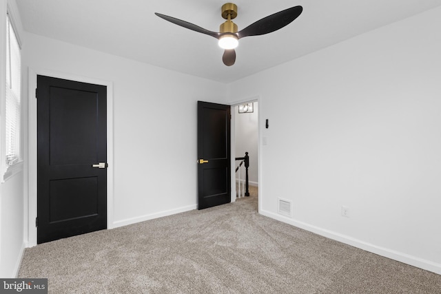 unfurnished bedroom with carpet floors and ceiling fan