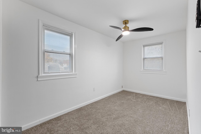 carpeted spare room with plenty of natural light and ceiling fan