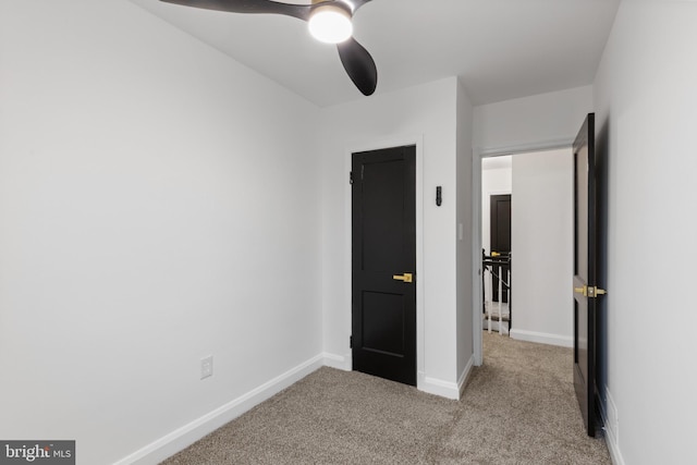 unfurnished bedroom with ceiling fan and light colored carpet