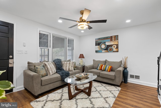 living room with dark hardwood / wood-style floors and ceiling fan