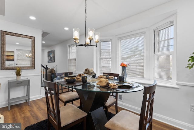 dining room featuring dark hardwood / wood-style floors and a notable chandelier