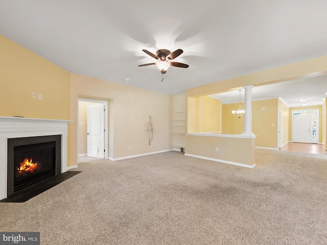 unfurnished living room featuring ceiling fan, decorative columns, and carpet floors