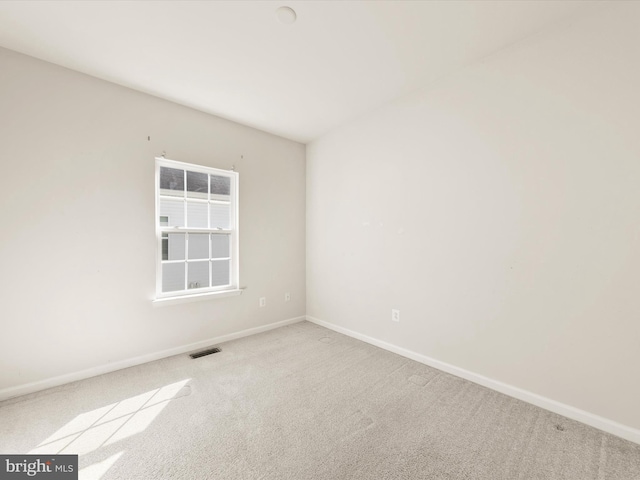 unfurnished room featuring light colored carpet