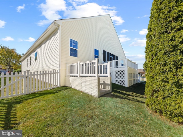 view of home's exterior featuring a yard and a deck