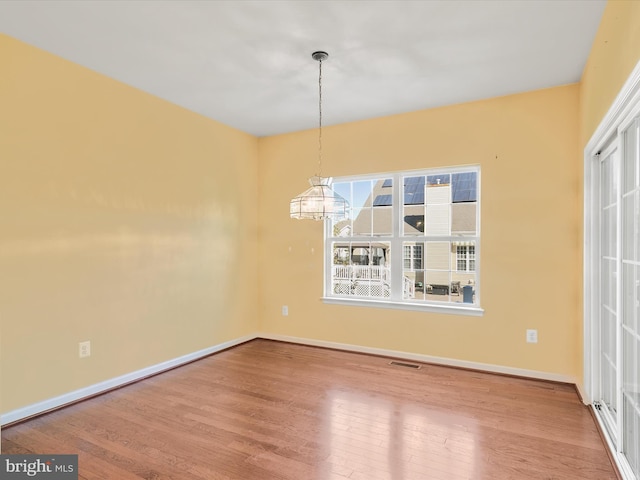 unfurnished dining area featuring hardwood / wood-style flooring