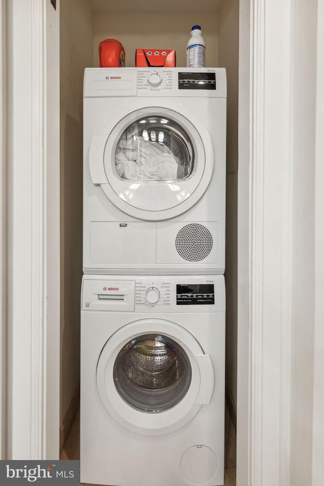 washroom featuring stacked washer and dryer