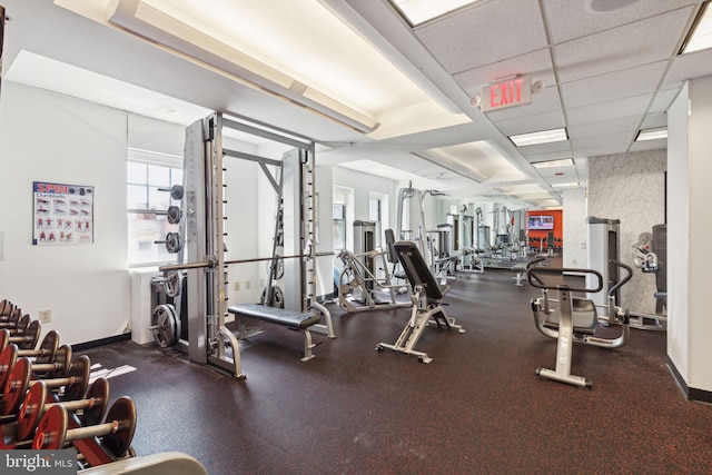 gym with a paneled ceiling