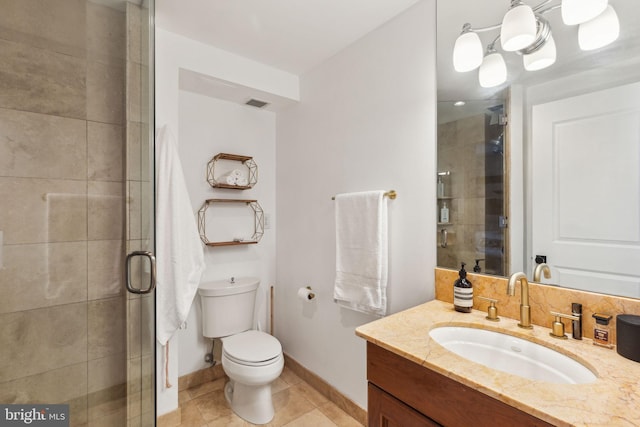 bathroom with an inviting chandelier, walk in shower, toilet, vanity, and tile patterned floors