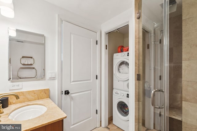 washroom featuring sink and stacked washer / drying machine