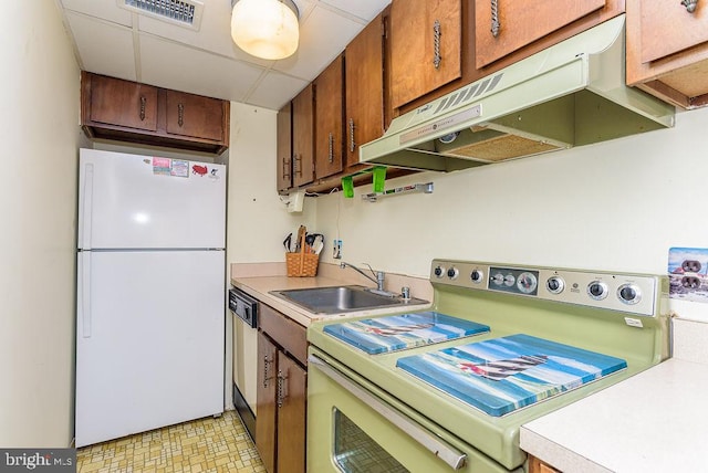 kitchen featuring white appliances and sink