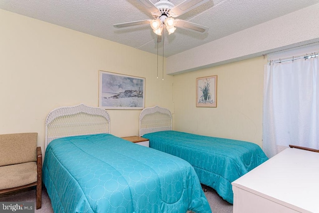 bedroom with ceiling fan, a textured ceiling, and carpet floors