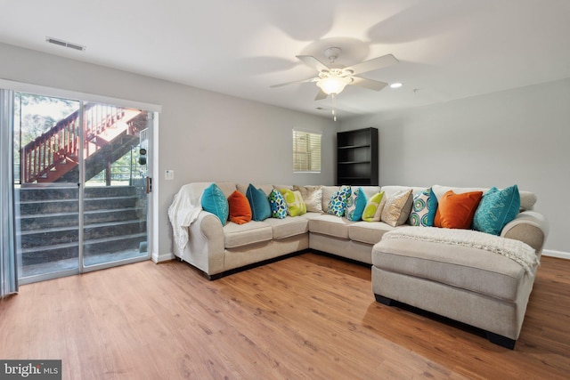 living room featuring hardwood / wood-style floors and ceiling fan