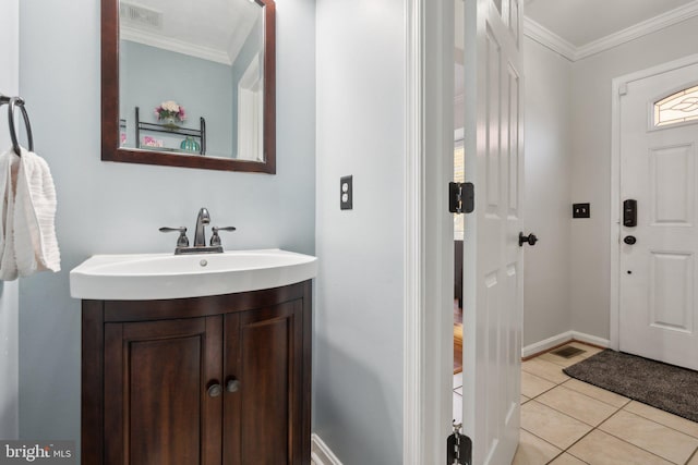 bathroom featuring vanity, crown molding, and tile patterned flooring