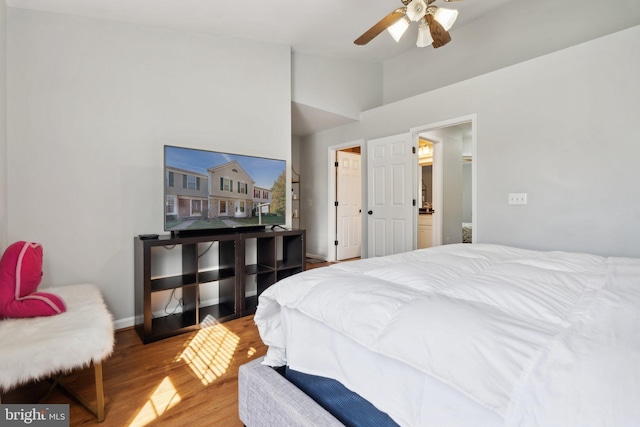 bedroom featuring hardwood / wood-style floors, high vaulted ceiling, and ceiling fan