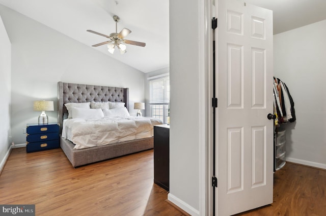 bedroom with lofted ceiling, wood-type flooring, and ceiling fan