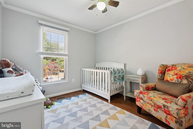 bedroom with multiple windows, ornamental molding, dark wood-type flooring, and ceiling fan