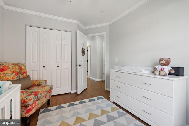 bedroom featuring dark wood-type flooring, a closet, and ornamental molding